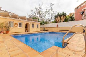 a swimming pool in the backyard of a house at 797 Holiday Rentals - Elegante apartamento para 2 en Torremolinos. in Torremolinos