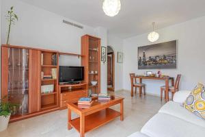a living room with a couch and a table at 797 Holiday Rentals - Elegante apartamento para 2 en Torremolinos. in Torremolinos