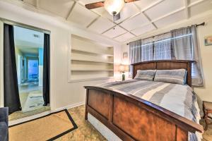 a bedroom with a bed and a ceiling fan at Jacksonville Getaway with Yard about 2 Mi to Beach! in Jacksonville