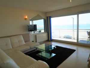 a living room with a white couch and a glass table at Quiberon: Appartement 3 pièces avec balcon et parking près du centre - FR-1-478-37 in Quiberon