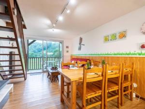 a dining room with a wooden table and chairs at Appartement duplex Saint-Lary 6 pers, 2 ch, mezzanine, balcon - FR-1-296-302 in Saint-Lary-Soulan +11 photos