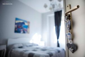 a bedroom with a bed and a door with hearts on it at Ciuri Ciuri B&B in Palermo