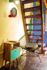 a room with a chair next to a wooden table at El Kamaruco Chaltén Tiny House de Montaña in El Chalten