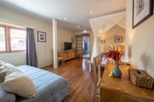 a bedroom with a bed and a table with a vase on it at Villa Amana Seminyak in Seminyak