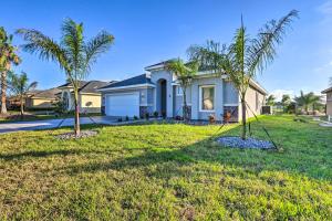 a house with palm trees in the yard at Stunning Laguna Vista Retreat with Pool and Grill in Laguna Vista