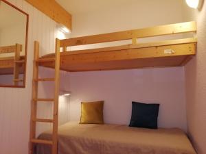 a bunk bed in a room with a bunk bed in a room at Studio Les Arcs 1800, 1 pièce, 4 personnes - FR-1-411-642 in Arc 1800