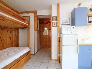 a kitchen with a refrigerator and a small room at Appartement Briançon, 2 pièces, 4 personnes - FR-1-330C-4 in Briançon