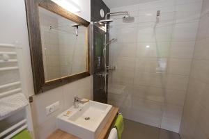 a bathroom with a sink and a shower at Gästehaus Steinerhof in Nikolsdorf