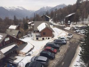 a group of cars parked in a parking lot with snow at Studio coin montagne à Risoul 1850 - FR-1-330-541 in Risoul +5 photos