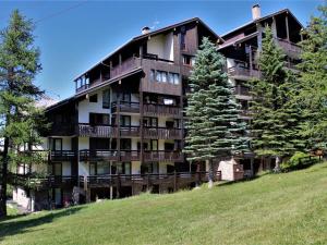 a large apartment building on a hill with trees at Studio coin montagne à Risoul 1850 - FR-1-330-541 in Risoul