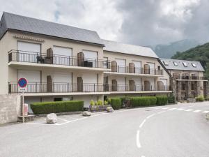 a building with balconies on the side of a road at Duplex rénové pour 4 à Saint-Lary près des pistes et commodités - FR-1-296-300 in Saint-Lary-Soulan