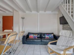 a living room with a couch and a table and chairs at Appartement Saint-Jean-de-Luz, 4 pièces, 6 personnes - FR-1-4-590 in Saint-Jean-de-Luz