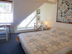 een slaapkamer met een bed met een quilt bij Appartement La Trinité-sur-Mer, 3 pièces, 4 personnes - FR-1-477-191 in La Trinité-sur-Mer