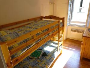 a bunk bed in a small room with a window at Maison Bagnères-de-Luchon, 4 pièces, 6 personnes - FR-1-313-158 in Luchon