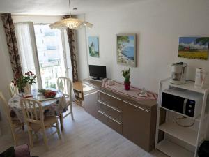 a kitchen and dining room with a desk and a table at Appartement Bagnères-de-Luchon, 2 pièces, 4 personnes - FR-1-313-151 in Luchon