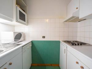 a kitchen with white cabinets and a green floor at Charmant 2 pièces, 1 chambre, balcon, animaux acceptés - FR-1-291-855 in Valmorel +3 photos