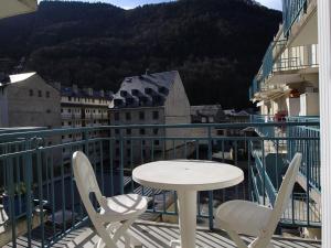 a table and chairs on a balcony with a view at Studio Cabine Calme, Parking, Balcon, Animaux Ok - 4 Pers. à Bagnères-de-Luchon - FR-1-313-193 in Luchon +2 photos