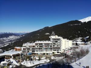 a large building on top of a snow covered mountain at Appartement Les Adrets-Prapoutel, 1 pièce, 4 personnes - FR-1-557-75 in Les Adrets