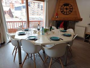 a dining room table with chairs and a large window at Bel appartement 6/8 pers avec balcon, au cœur de Val Thorens - FR-1-545-21 in Val Thorens +9 photos