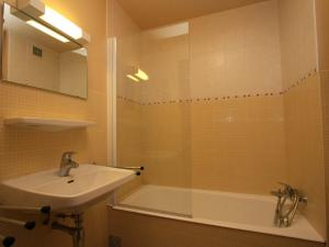 a bathroom with a shower and a sink and a tub at Studio Le Grand-Bornand, 1 pièce, 4 personnes - FR-1-458-89 in Le Grand-Bornand