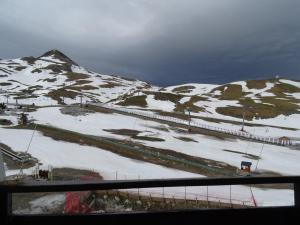 a snow covered mountain with a train on it at Studio au pied des pistes pour 5 pers. avec balcon, casier à skis, et parkings gratuits - La Pierre St Martin - FR-1-602-67 in Arette +1 photo