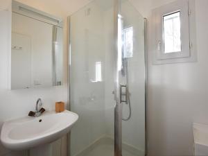 a white bathroom with a sink and a shower at Maison Les Portes-en-Ré, 5 pièces, 6 personnes - FR-1-434-70 in Les Portes