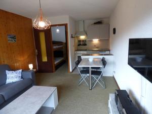 a small living room with a couch and a table at Studio Le Grand-Bornand, 1 pièce, 4 personnes - FR-1-458-113 in Le Grand-Bornand