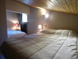 a bedroom with a large bed and a window at Appartement Le Grand-Bornand, 4 pièces, 8 personnes - FR-1-458-138 in Le Grand-Bornand