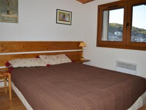 a bedroom with a large bed with a window at Appartement Les Angles, 3 pièces, 4 personnes - FR-1-593-31 in Les Angles