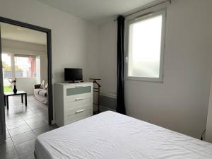 um quarto com uma cama, um espelho e uma janela em Appartement Cambo-les-Bains, 2 pièces, 2 personnes - FR-1-495-94 em Cambo-les-Bains