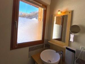 a bathroom with a sink and a mirror and a window at Appartement Barèges, 2 pièces, 4 personnes - FR-1-403-97 in Barèges