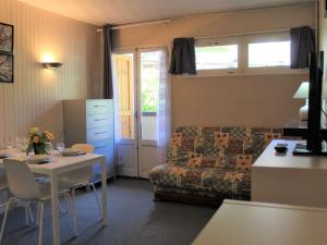 a living room with a table and a couch at Studio 4 Pers à Vars - Emplacement Idéal Proche Pistes et Commerces - FR-1-330B-179 in Vars