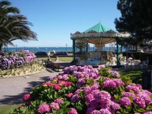 a garden with purple flowers and a gazebo at Appartement 3 étoiles avec Wifi à Perros-Guirec - FR-1-542-42 in Perros-Guirec