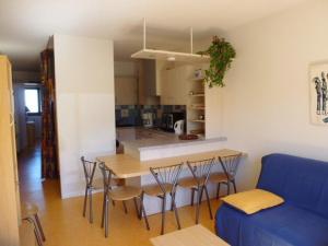 a kitchen and living room with a table and chairs at Appartement Arette, 2 pièces, 6 personnes - FR-1-602-60 in Arette