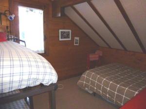 1 dormitorio en el ático con cama y ventana en Chalet Arette, 4 pièces, 6 personnes - FR-1-602-80, en Arette