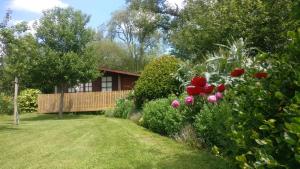 a house with a garden with flowers in front of it at The Cider Shed Bed and Breakfast in Wareham