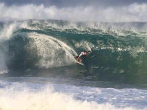 a man riding a wave on a surfboard in the ocean at Appartement Vieux-Boucau-les-Bains, 2 pièces, 4 personnes - FR-1-379-132 in Vieux-Boucau-les-Bains