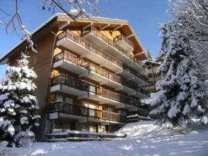 a large building in the snow with snow covered trees at Appartement Méribel, 3 pièces, 6 personnes - FR-1-180-565 in Les Allues