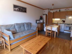 a living room and kitchen with a couch and a table at Appartement Le Grand-Bornand, 2 pièces, 6 personnes - FR-1-458-109 in Le Grand-Bornand