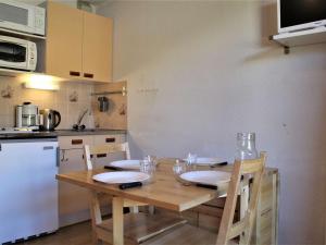a kitchen with a wooden table with glasses on it at Appartement Risoul, 2 pièces, 4 personnes - FR-1-330-525 in Risoul