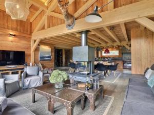 a living room with a table and a fireplace at Chalet Morzine, 6 pièces, 13 personnes - FR-1-627-8 in Morzine