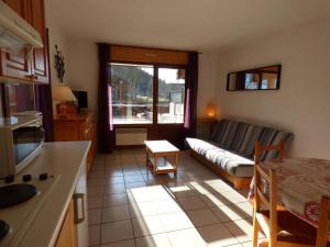 a living room with a couch and a table at Appartement Le Grand-Bornand, 3 pièces, 6 personnes - FR-1-458-118 in Le Grand-Bornand