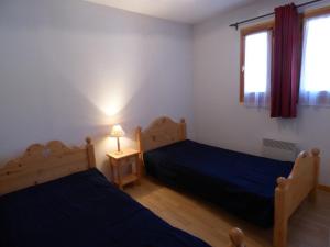 a bedroom with two beds and a window at Appartement Saint-Jean-de-Sixt, 3 pièces, 6 personnes - FR-1-458-134 in Saint-Jean-de-Sixt