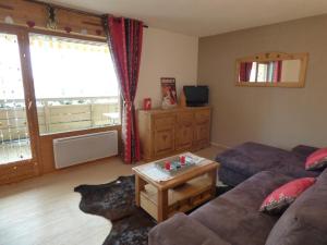 a living room with a couch and a table at Appartement Le Grand-Bornand, 2 pièces, 6 personnes - FR-1-458-142 in Le Grand-Bornand