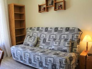 a couch sitting in a living room with a lamp at Appartement Vars, 1 pièce, 4 personnes - FR-1-330B-178 in Vars