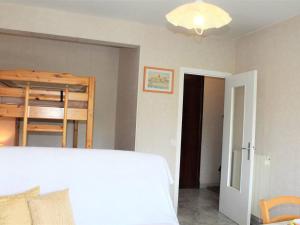a bedroom with a bed and a bunk bed at Appartement Cagnes-sur-Mer, 1 pièce, 4 personnes - FR-1-252A-56 in Cagnes-sur-Mer