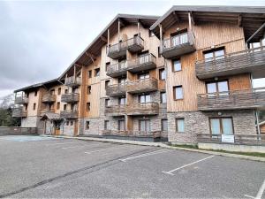 an apartment building with balconies and a parking lot at Appartement cosy avec terrasse, proche télésiège et piscine - 4 pers, Wifi inclus, Dévoluy - FR-1-525-217 in Le Dévoluy +7 photos