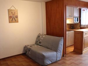 a living room with a blue couch in a kitchen at Studio cosy avec coin montagne, balcon, à 100m des pistes et 10m des commerces à Vars Les Claux - FR-1-330B-184 in Vars +11 photos