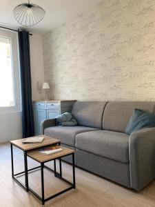 a living room with a couch and a table at Les Beaux Jours, Tours, le Duplex in Tours
