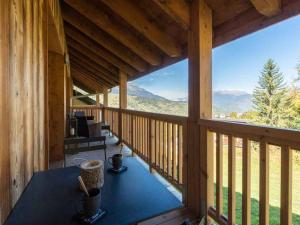 a view from the porch of a log cabin with a table at Appartement Les Avanchers-Valmorel, 4 pièces, 8 personnes - FR-1-291-869 in Valmorel